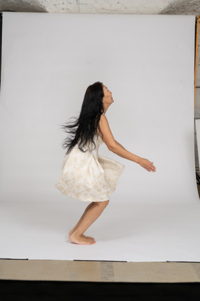 Woman in beautiful dress jumping