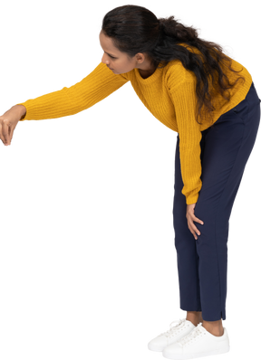 Side view of a girl in casual clothes bending down and explaining something