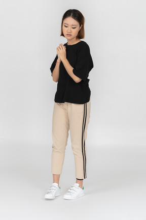 Young woman standing and thinking about something