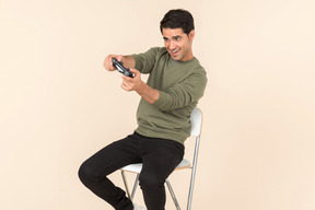 Young caucasian guy playing a videogame
