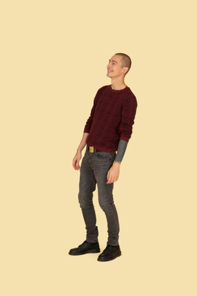 Three-quarter view of a laughing young men in casual clothes leaning back