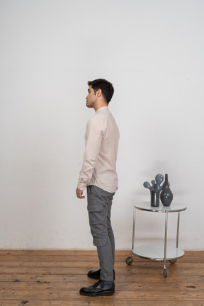 Man in casual clothes standing in profile