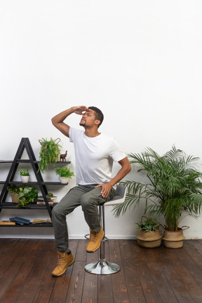 Good looking young man sitting on a chair