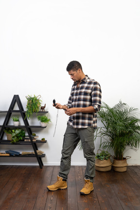 Three-quarter view of a tourist examining his compass