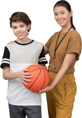 Pe teacher and pupil holding basketball ball
