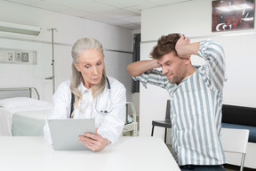 A doctor and a patient looking at a tablet