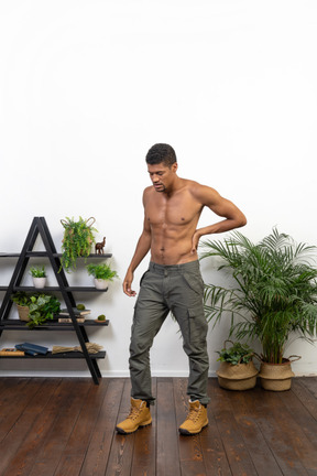 Good looking young muscular man feeling pain