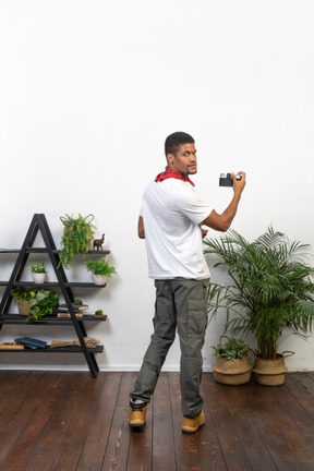 Good looking young man with a camera