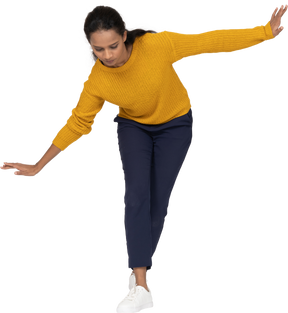 Front view of a girl in casual clothes bending down with outstretched arms