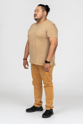 A man standing with his eyes closed