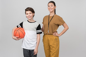 Smiling physical education teacher and pupil