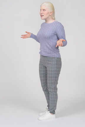 Young woman spreading arms and talking